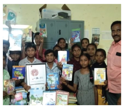 Students receiving certificates and books